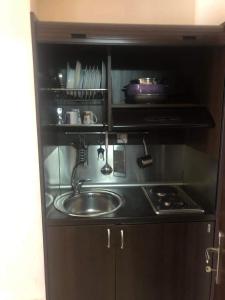 a kitchen with a sink and a stove at Bella Vista Apartments in Nea Vrasna