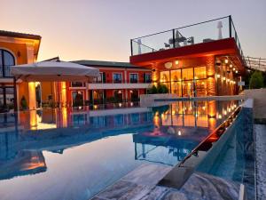 a swimming pool in front of a building at ECO Therma Village - All inclusive & Private Beach & Free Parking in Kranevo