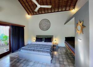a bedroom with a bed and a large window at Villa Saia in Gili Air