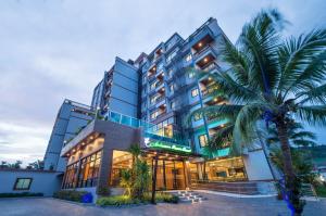 奧南海灘的住宿－Andaman Breeze Resort - SHA Plus，前面有棕榈树的酒店