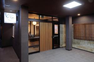 郡山市にあるTabist 温泉プチホテル 湯kori 磐梯熱海の門看板のある建物の廊下