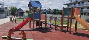 a playground with a slide and a slideintend at Gardenia Sea Side MARTINA 1 Dziwnów in Dziwnów