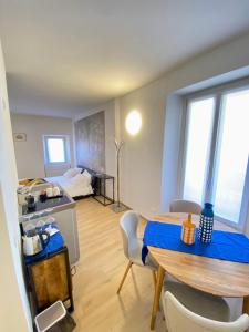 a kitchen and dining room with a table and chairs at Isola Bella Studios in Stresa