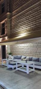 a living room with white couches and a brick wall at Cenk Bey Hotel in Fethiye