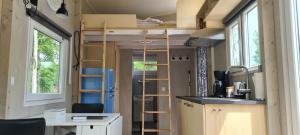 a tiny house with a loft bed and a desk at Vakantiepark 't Urkerbos -Tiny house in Urk