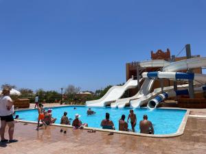 a group of people in a pool at a water park at Dream Lagoon Resort & Aqua Park in Marsa Alam City