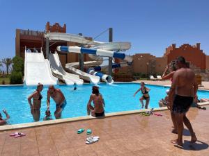a group of people playing in a swimming pool at Dream Lagoon Resort & Aqua Park in Marsa Alam City
