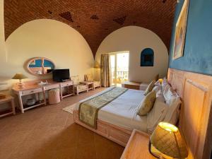 a bedroom with a large bed in a room with arches at Dream Lagoon Resort & Aqua Park in Marsa Alam City