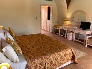 a bedroom with a bed and a desk and a television at Dream Lagoon Resort & Aqua Park in Marsa Alam City