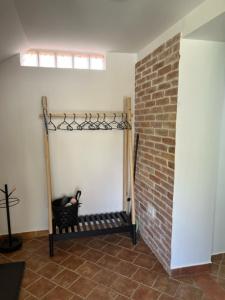 a room with a brick wall and a black chair at Apartma ELA in Zgornje Gorje