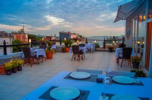 eine Terrasse mit Tischen und Stühlen auf dem Balkon in der Unterkunft Sarnic Premier Hotel in Istanbul