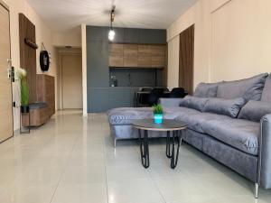 a living room with a couch and a table at Luxury Apartment Keramoti in Keramotí