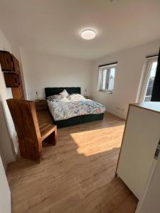 a bedroom with a bed and a wooden floor at Suite 110qm nahe Rhein in Krefeld