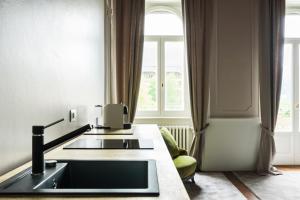 a kitchen with a sink in front of a window at Piazza Cavour - Lake view Apartment in Como