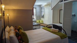 A bed or beds in a room at Wayside Inn Knysna