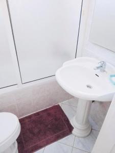 a bathroom with a white sink and a toilet at Vila Murdeira in Palha Verde +13 photos