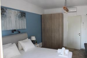 Postel nebo postele na pokoji v ubytování Alios Geron Blue