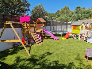 a backyard with a playground with slides and a play structure at Amoremio in Peypin
