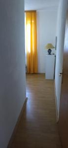 an empty room with a window and a wooden floor at Apartments Mara Seget Vranjica in Seget Vranjica