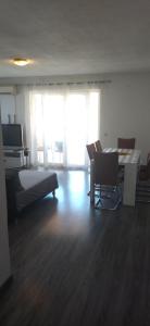 a room with a bedroom with a bed and a desk at Apartments Mara Seget Vranjica in Seget Vranjica