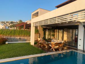 a house with a swimming pool next to a house at Villa Aleph-Kiralık Müstakil havuzlu lüx villa in Bodrum City