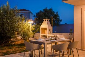 a dining table and chairs on a patio at Montagna & Mare villa in Kefallonia