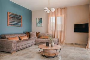 a living room with a couch and a table at Montagna & Mare villa in Kefallonia
