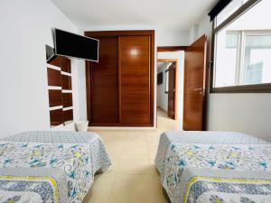 Кровать или кровати в номере Apartamento Muelle Deportivo