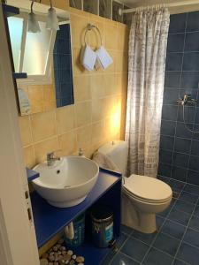 a bathroom with a sink and a toilet at Evdilos' Balcony in Evdilos +38 photos