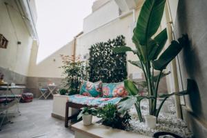 a living room with a couch and a bunch of plants at Dimora Fantasia Charme B&B in Bari