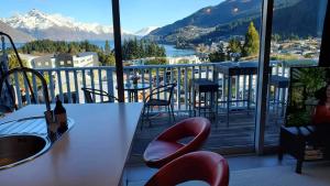 a balcony with a table and chairs and a view at Central Lakeview Apartment with amazing rooftop 镇上湖景三室套房 in Queenstown +30 photos