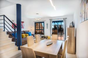 a dining room and living room with a wooden table at Casa Marine in Lajita