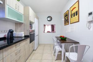 a kitchen with a table and a counter top at Casa sol in Vélez-Málaga