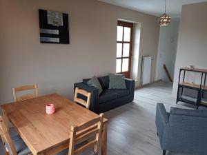 a living room with a table and a couch at Au Bon pl'Han in Han-sur-Lesse