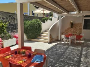 a patio with a table and chairs and a staircase at Lido Di Procida Guest House in Procida