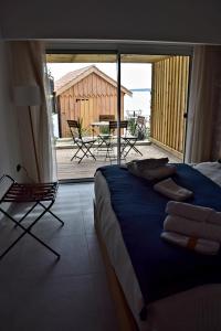 a bedroom with a bed and a view of a patio at Hôtel L'Albatros in Saint-Trojan-les-Bains