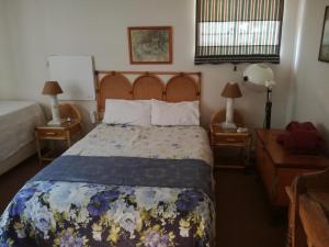 A bed or beds in a room at Valley Guest House