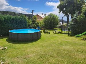 a large pool in a yard with a playground at Pension Salma in Černý Dŭl