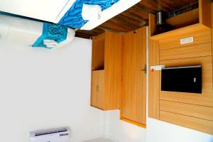 a small room with a bed and a cupboard at Hotel Diamond View in Amritsar