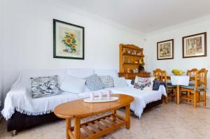 a living room with a couch and a table at YourHouse Ca Na Maria in Son Serra de Marina