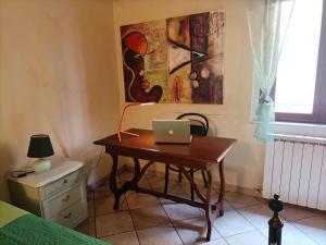 a desk with a laptop on it in a bedroom at Il Gioiellino di Modena - Elegant Apartment[☆☆☆☆☆] in Modena