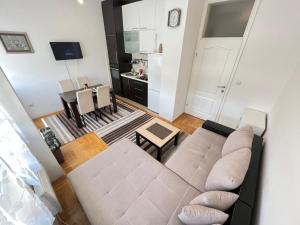 a living room with a couch and a table at Jimmy's Apartment in Sarajevo