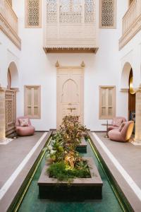 a room with a pool in the middle of a building at Riad Nyla Wellness and Spa in Marrakesh