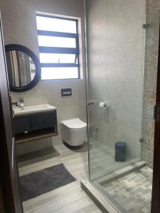 a bathroom with a shower and a toilet and a sink at 365@ Vaal De Grace Parys in Parys