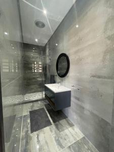 a bathroom with a sink and a shower and a mirror at 365@ Vaal De Grace Parys in Parys