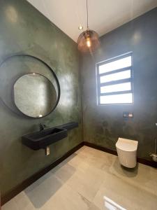 a bathroom with a sink and a mirror at 365@ Vaal De Grace Parys in Parys