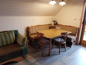 a dining room with a table and chairs and a couch at Trippolthof in Prebl