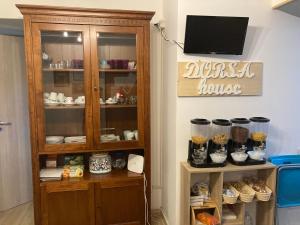 a room with a wooden cabinet with food in it at dorshaouse in Civitavecchia