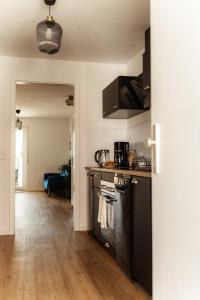 a kitchen with a stove and a counter top at Casa d‘Oro in Friedrichshafen +11 photos