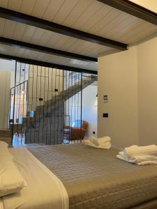 a bedroom with a bed with a staircase in the background at Loft 56 in Porto SantʼElpidio